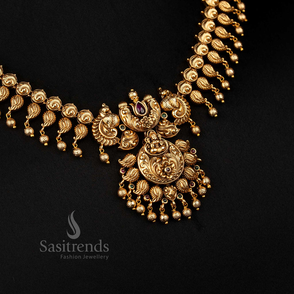 Opulent ruby-green matte gold plated temple floral peacock Lakshmi necklace featuring golden ball hangings, ideal to wear for grand traditional events and festive occasions – Sasitrends