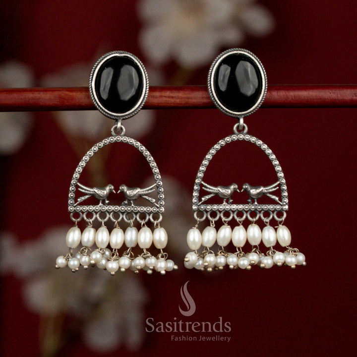 Beautiful antique oxidised 92.5 silver plated earrings featuring black oval Monalisa stone, spherical arch dual bird motif and rice pearl hangings for bold cultural styling - Sasitrends