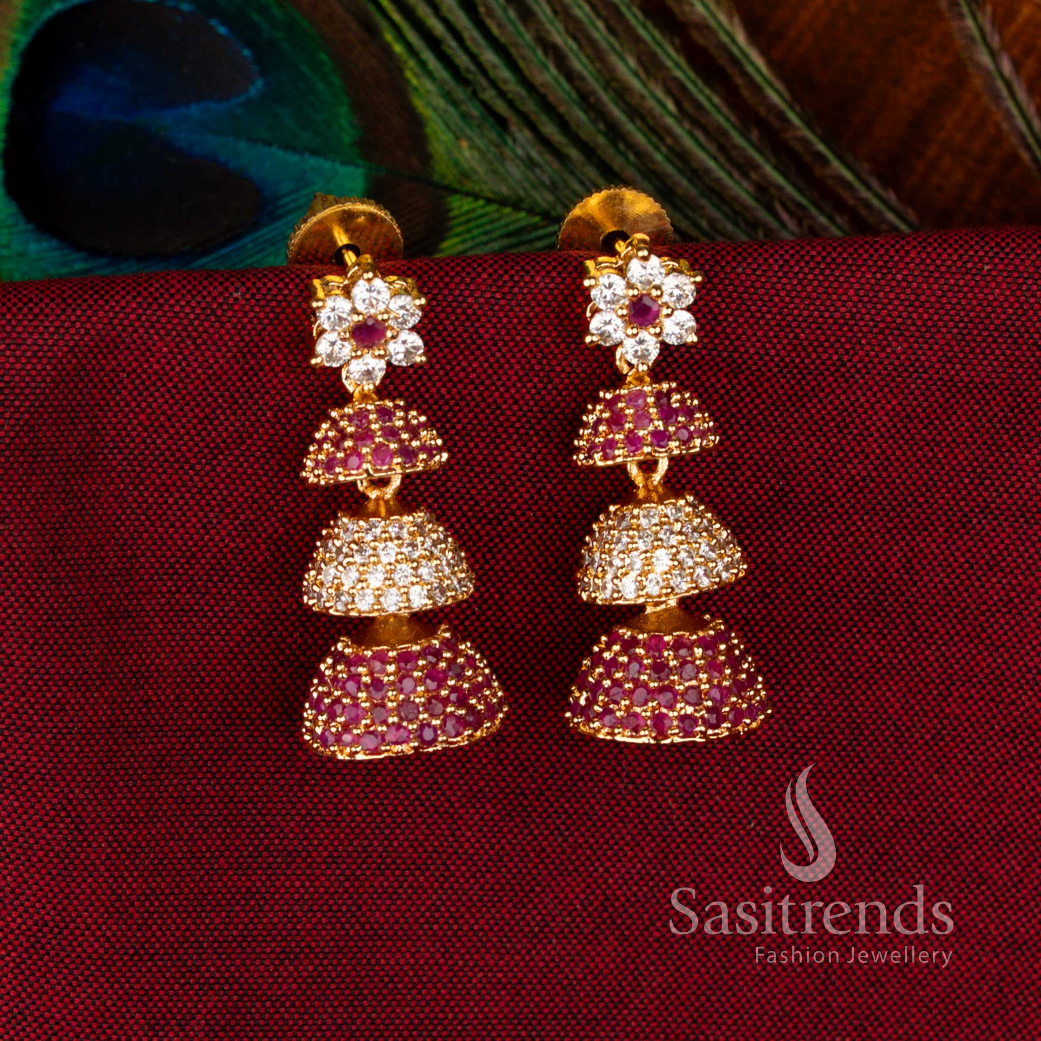 Exquisite Gold Plated Brass Triple-Layer Jhumkas with American Diamond Embellishments in White-Ruby Colour, Ideal Jewellery for Parties and Traditional Functions – Sasitrends
