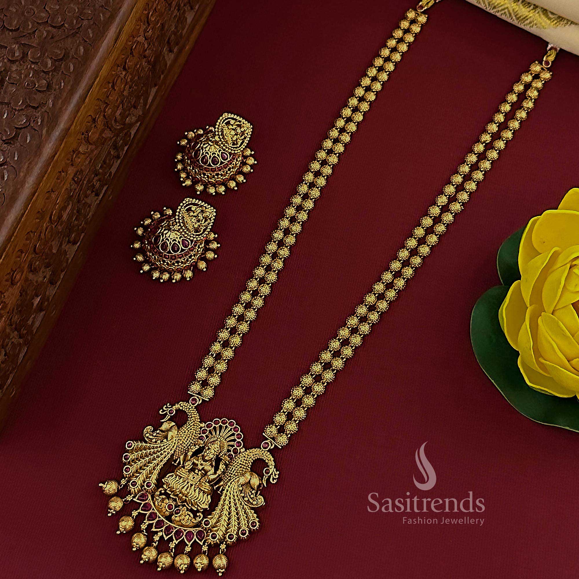 Royal ruby temple matte gold plated 2 layered long jewellery set with majestic Lakshmi peacock pendant and ornate jhumkas, crafted for the traditional bride seeking refined opulence – Sasitrends

