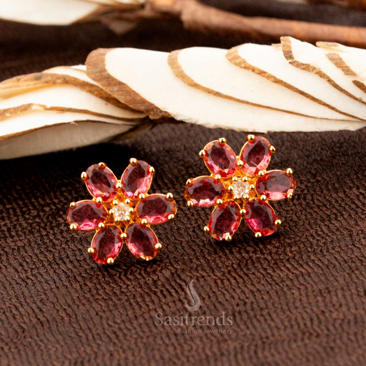 Dazzling gold-plated American diamond floral stud earrings featuring vibrant ruby stones, a stunning jewellery piece for festive outfits, bridal ensembles, and party styling - Sasitrends