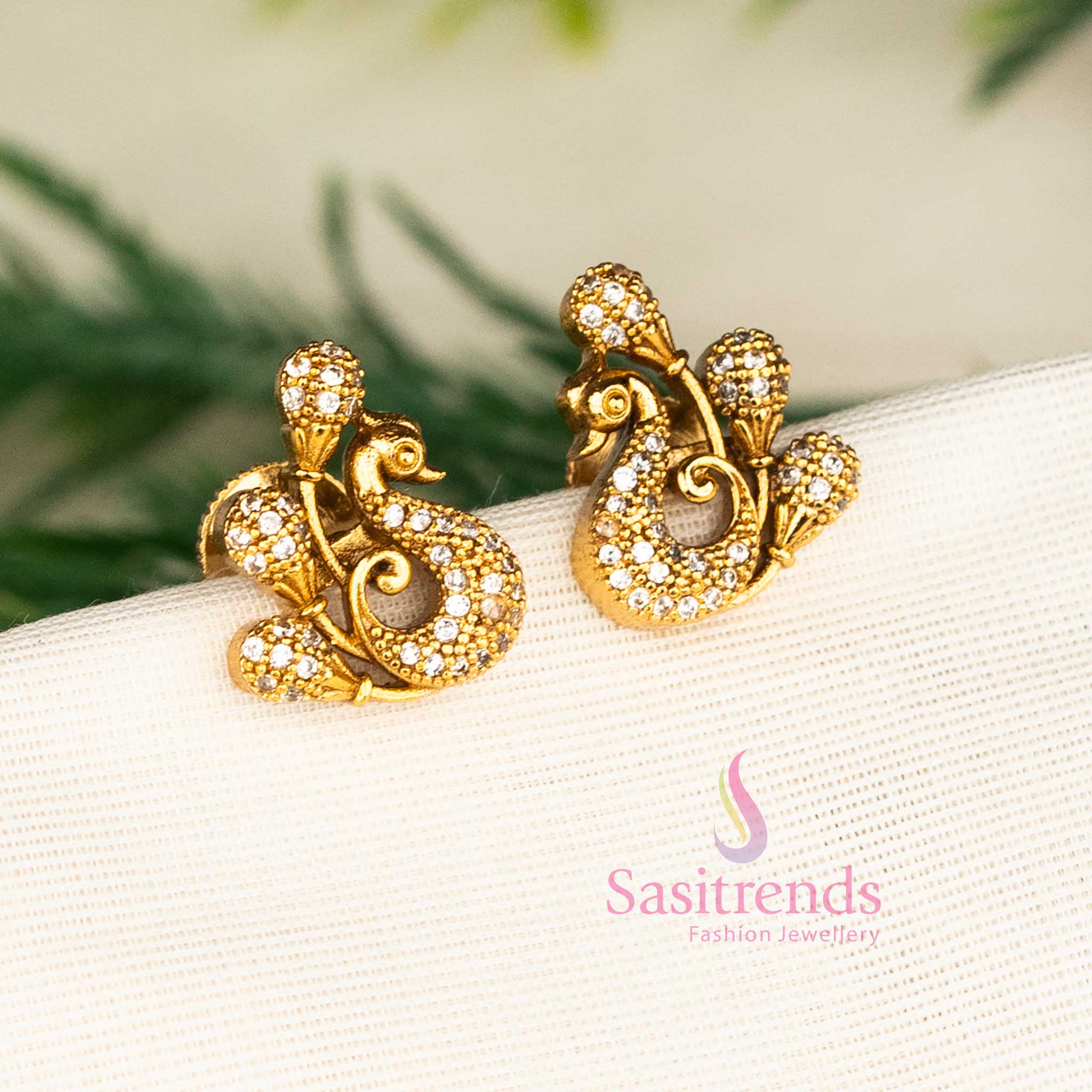 Matte gold white peacock stud earrings featuring diamond-like American stones and graceful floral design for elegant occasions and party wear by Sasitrends.