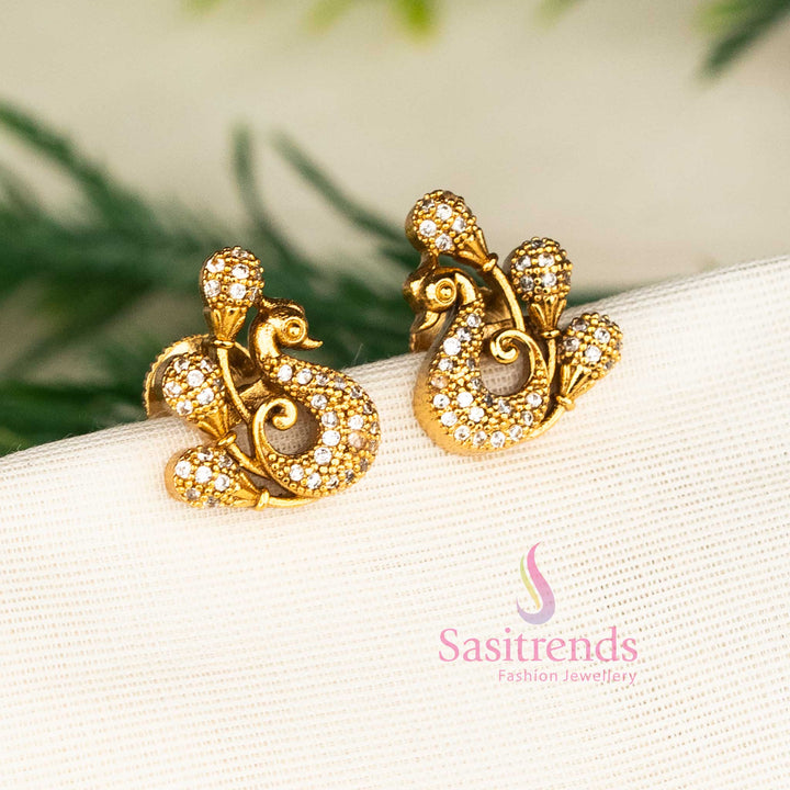 Matte gold white peacock stud earrings featuring diamond-like American stones and graceful floral design for elegant occasions and party wear by Sasitrends.