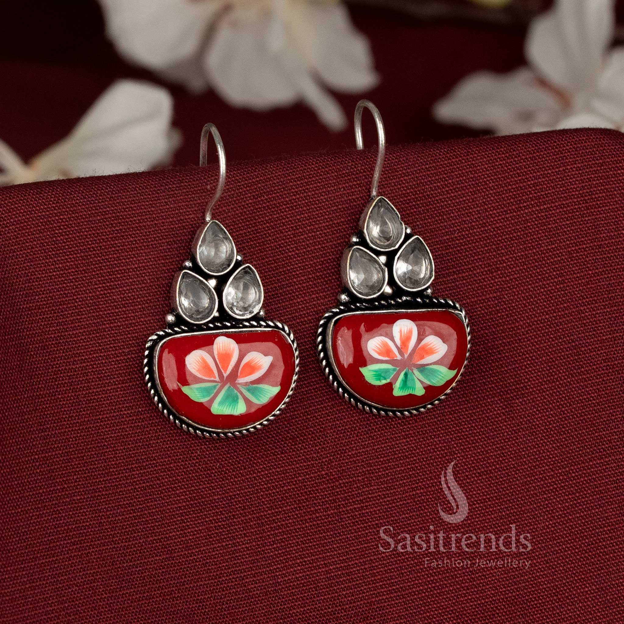 Amber hues oxidised earrings decorated with orange Monalisa stones and expressive bloom detailing – Sasitrends