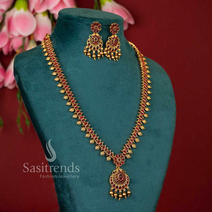 Grand temple motif ruby accented flower design long haram necklace set in matte gold plating for traditional elegance jewellery – Sasitrends