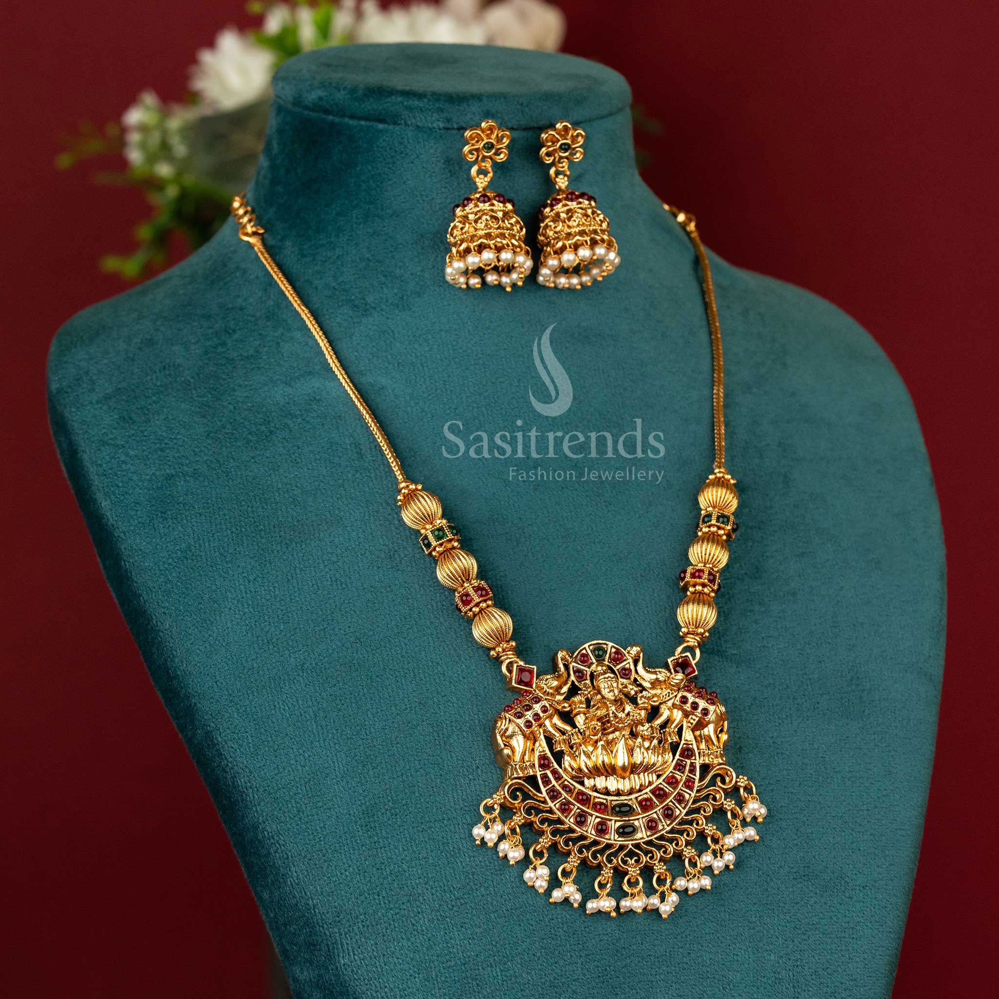 Handcrafted temple necklace with a vibrant ruby-green Lakshmi pendant and delicate floral jhumkas – ideal for ethnic celebrations and traditional gatherings – Sasitrends