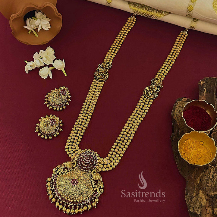 Traditional ruby temple matte gold tone Lakshmi long jewellery set with rich kemp stone detailing and charming jhumkas, perfect for elegant wedding wear – Sasitrends

