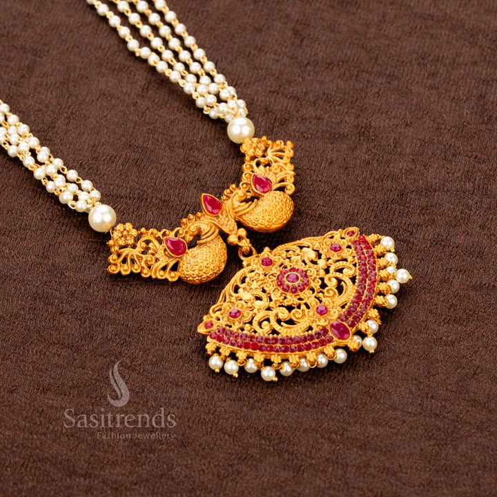  Temple-style classic matte gold necklace jewellery set with bold ruby ZX synthetic stones, peacock motif centerpiece, and pearl jhumkas—offering a royal ethnic finish with divine detailing - Sasitrends