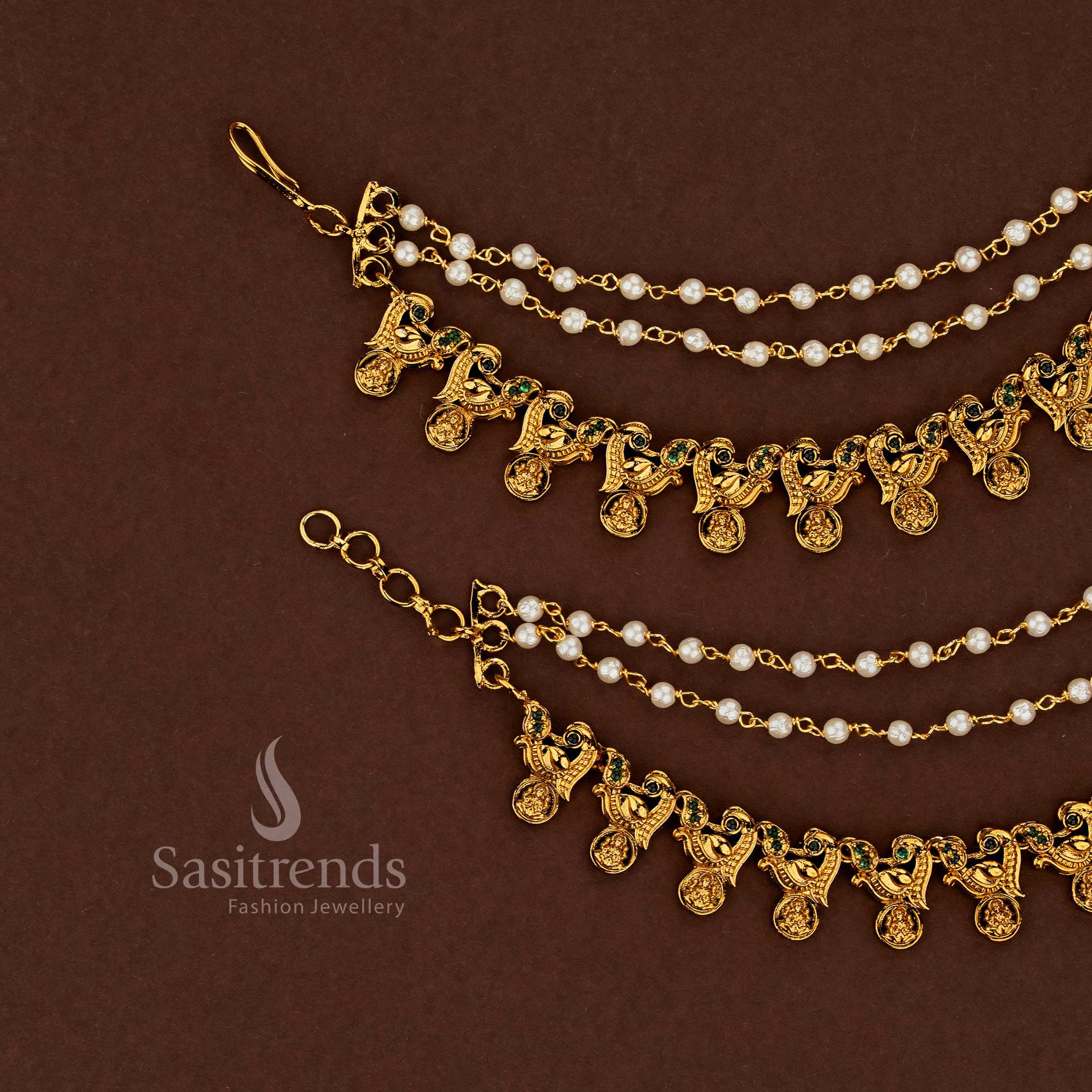 Regal Lakshmi motif temple matte gold plated American diamond matil ear chains adorned with vibrant green stones and classic pearl embellishments for ceremonial wedding wear - Sasitrends