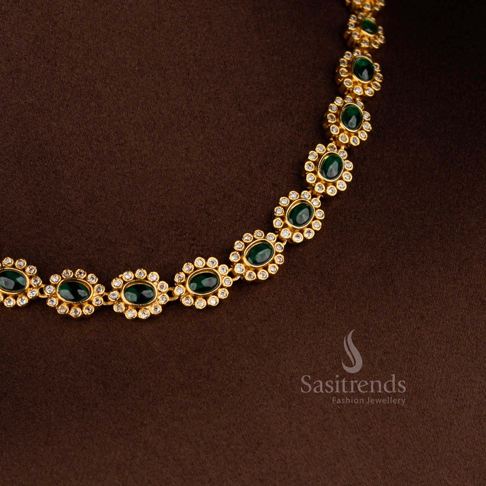 Matte gold plated green-colored oval floral AD earrings for festive ensembles, silk sarees, and ethnic parties – Sasitrends