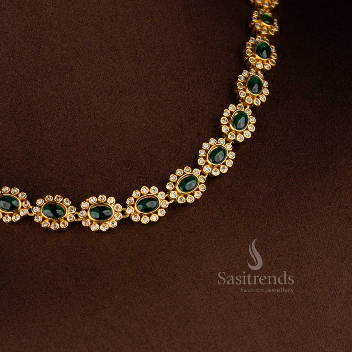 Matte gold plated green-colored oval floral AD earrings for festive ensembles, silk sarees, and ethnic parties – Sasitrends