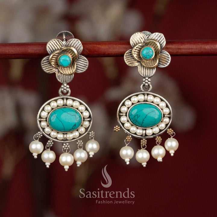 Artistic oxidised silver floral stud earrings featuring turquoise-blue Monalisa stones, intricate floral motifs and pearl cluster drops for lively festive wear - Sasitrends