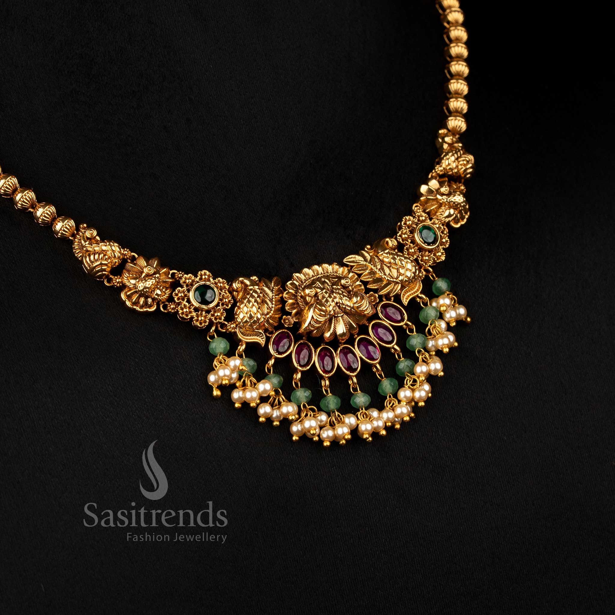 Majestic ruby-green premium matte gold plated dual peacock floral necklace featuring pearl drops, crafted to wear for cultural festivals and temple celebrations – Sasitrends