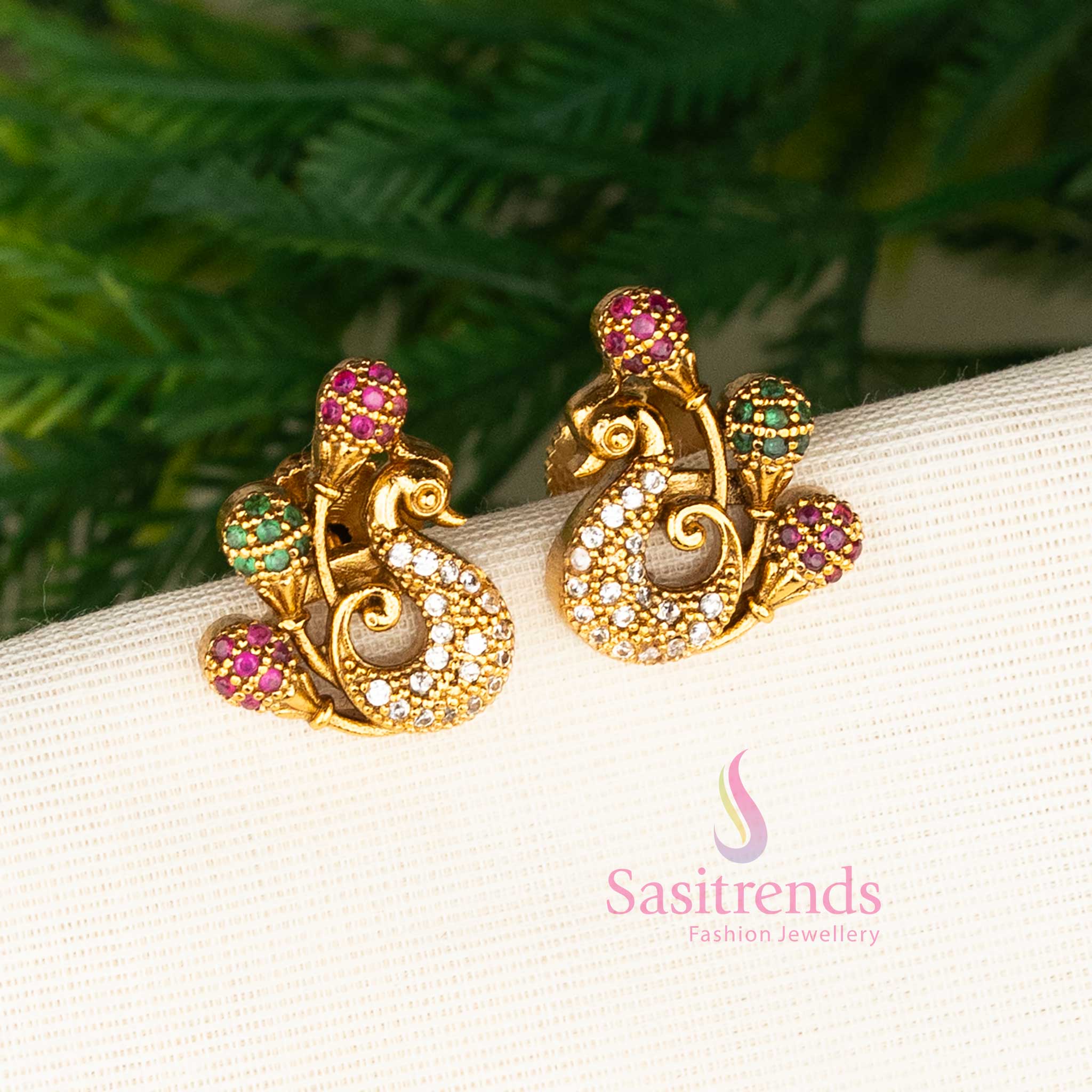 Colourful matte gold multi-stone peacock stud earrings featuring sparkling American diamonds for a gorgeous ethnic party look and festive charm by Sasitrends.