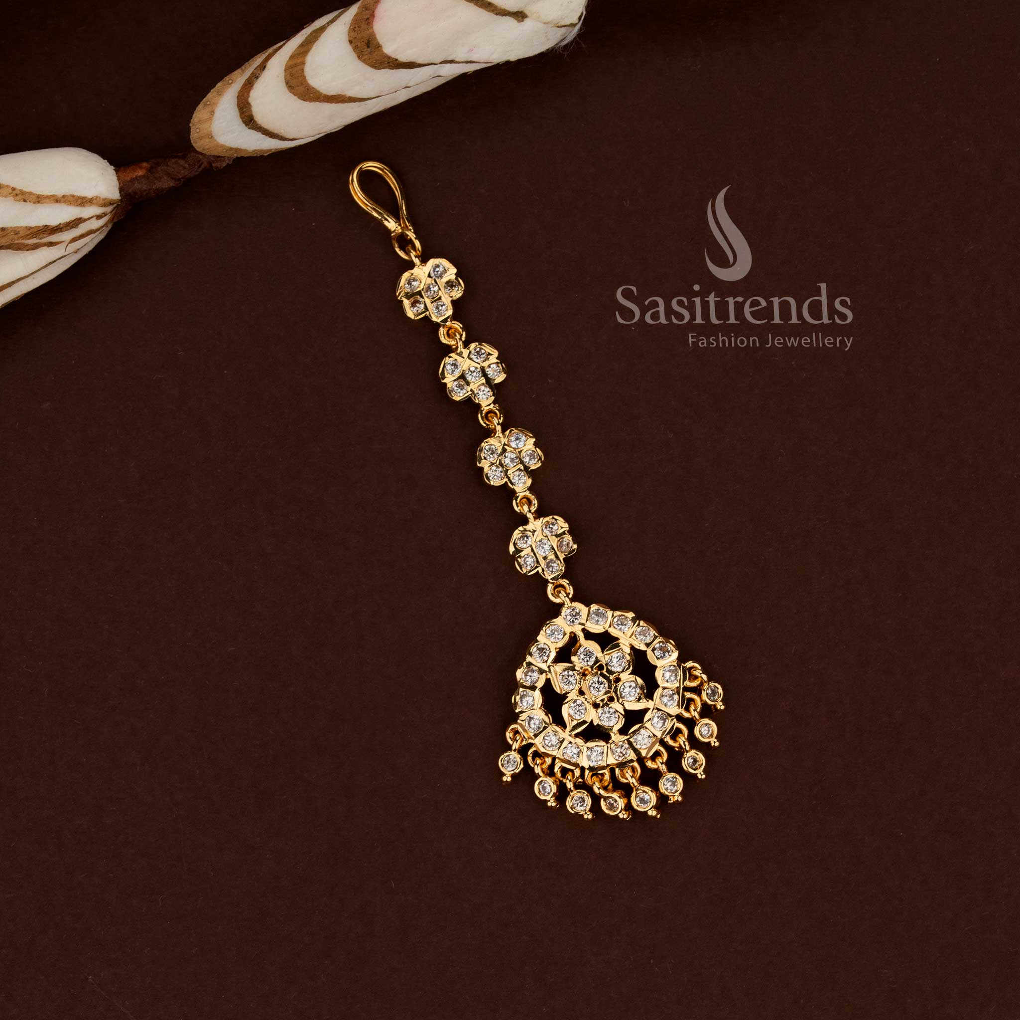 Vibrant white colour floral pattern Impon micro gold plated AD maang tikka designed for bridal fashion wedding functions festive outfits and ethnic celebration styling - Sasitrends