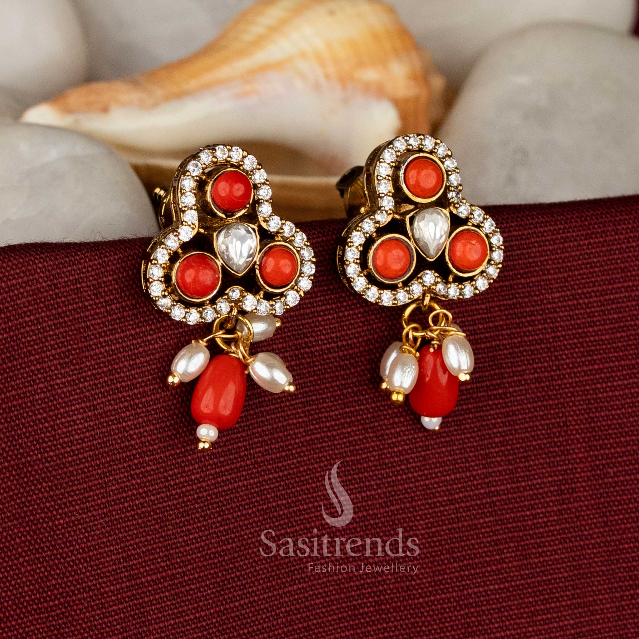Tangerine regalia Victorian three-lobed stud earrings featuring rich coral AD stones and floating pearl drops for festive charm – Sasitrends