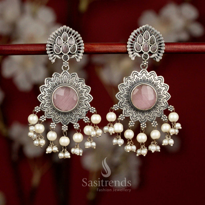 Antique 92.5 oxidised silver plated earrings featuring pink Monalisa teardrop stones, fanned peacock feather sun floral motif and soft pearl drops for graceful party styling - Sasitrends