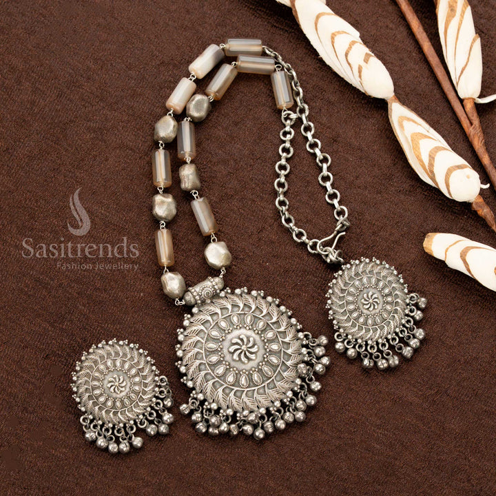 Vintage oxidised silver statement necklace, featuring burnished brown gemstones, a round floral pendant, and classic earrings, perfect for elevating traditional saree jewellery looks - Sasitrends