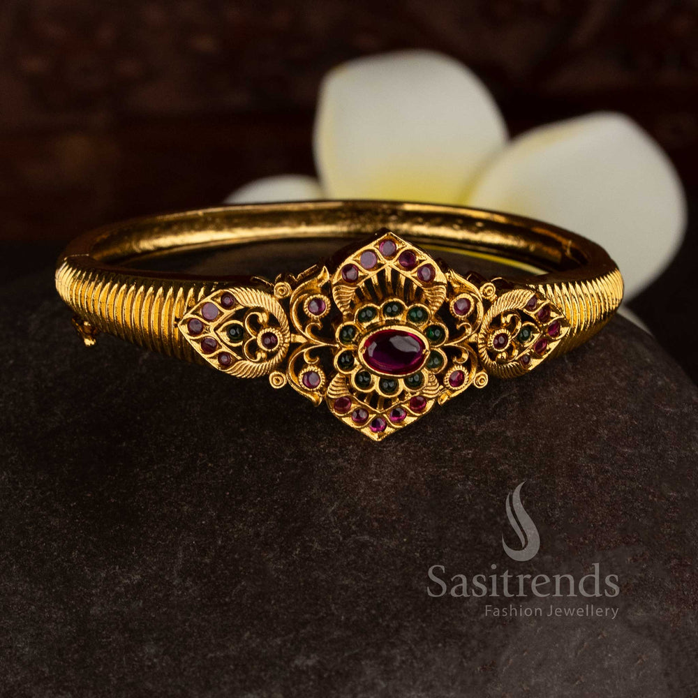 Temple matte gold plated ruby green AD stone single kada bracelet featuring floral centre motif and peacock-inspired side detailing, premium traditional temple jewellery with rich finish - Sasitrends