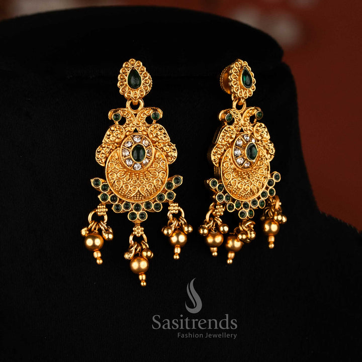 Classic matte gold plated dual peacock earrings in white-green with oval and teardrop stones, golden beads for festive and ethnic wear jewellery – Sasitrends