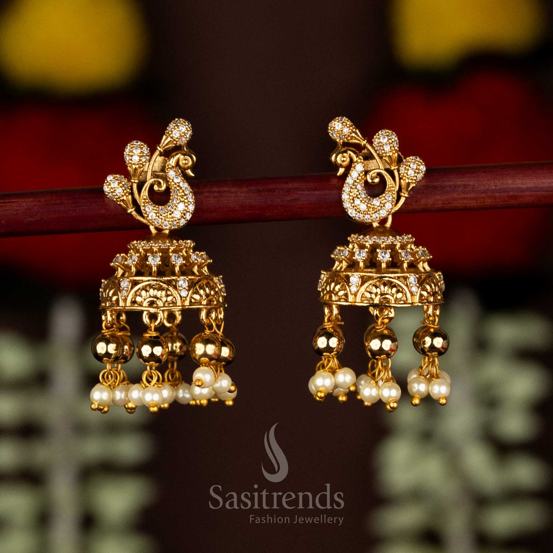 Heritage white matte gold plated peacock AD jhumka earrings with delicate pearl and bead hangings – Sasitrends