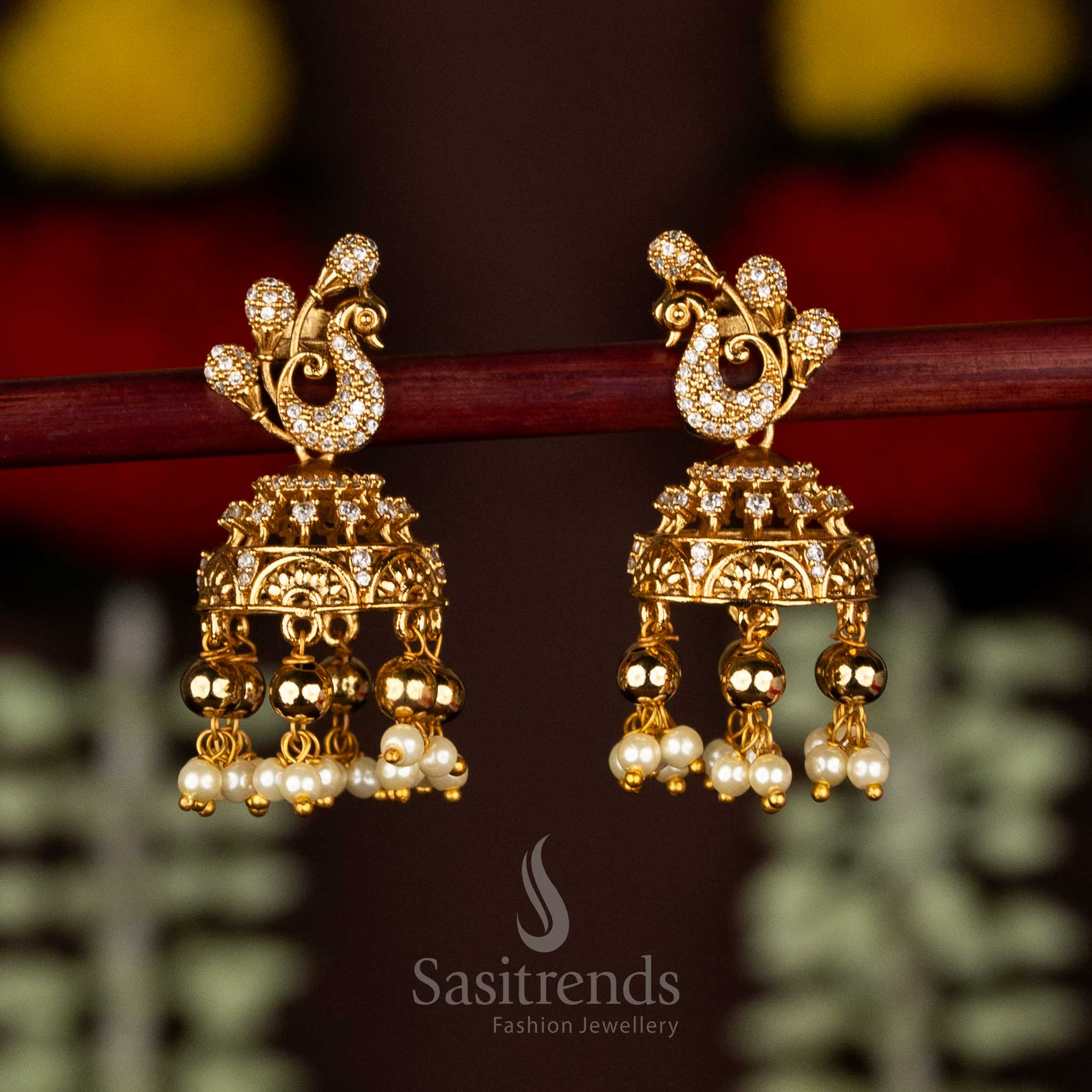 Heritage white matte gold plated peacock AD jhumka earrings with delicate pearl and bead hangings – Sasitrends