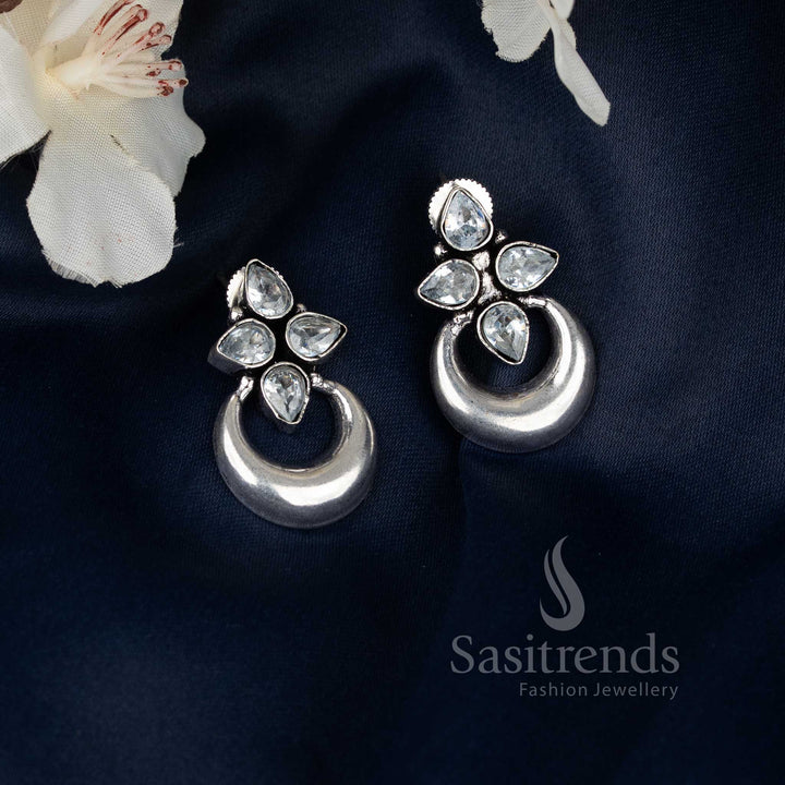 Elegant white oxidised floral half moon design earrings that bring subtle festive grace and ethnic heritage inspiration to Navaratri celebrations by Sasitrends