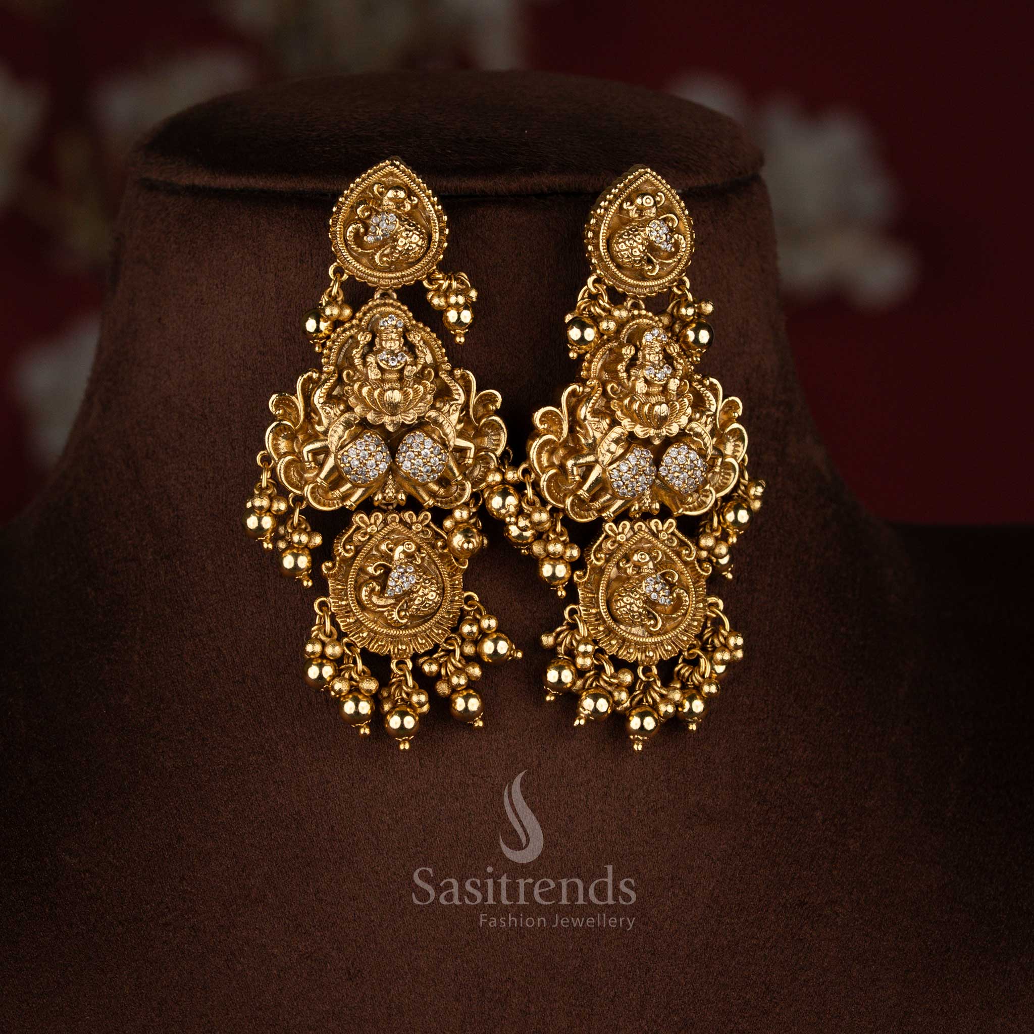 Heritage white premium matte gold plated temple Lakshmi dual peacock drop earrings ideal for grand traditional functions and classical bridal styling – Sasitrends
