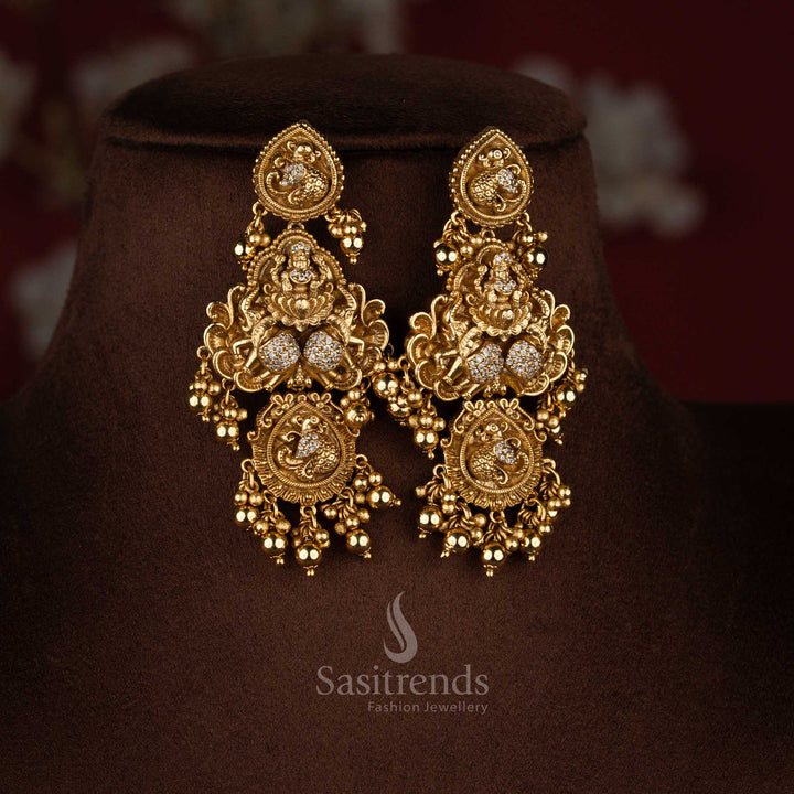 Heritage white premium matte gold plated temple Lakshmi dual peacock drop earrings ideal for grand traditional functions and classical bridal styling – Sasitrends