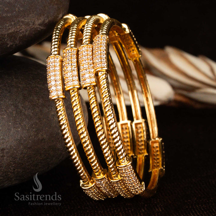 Micro gold plated traditional bangles set with radiant white American diamond stones and ruby-studded floral motifs – a captivating ethnic jewellery piece for bridal and festive elegance by Sasitrends