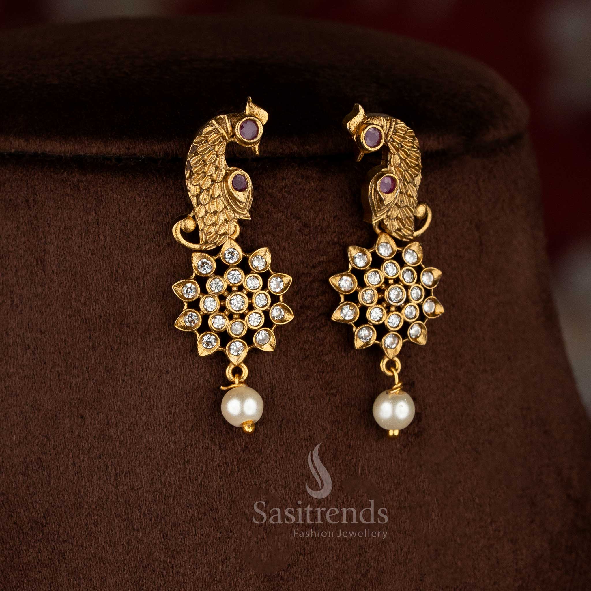 Charming American diamond matte gold plated white-ruby floral peacock earrings for celebration-ready saree dressing – Sasitrends
