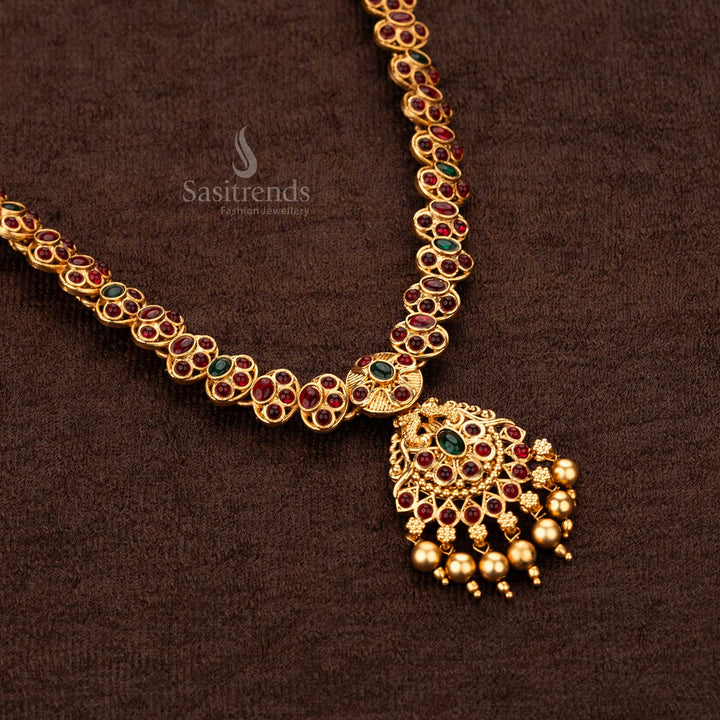 Close-up view of temple ruby green necklace pendant with golden pearl drops- Sasitrends