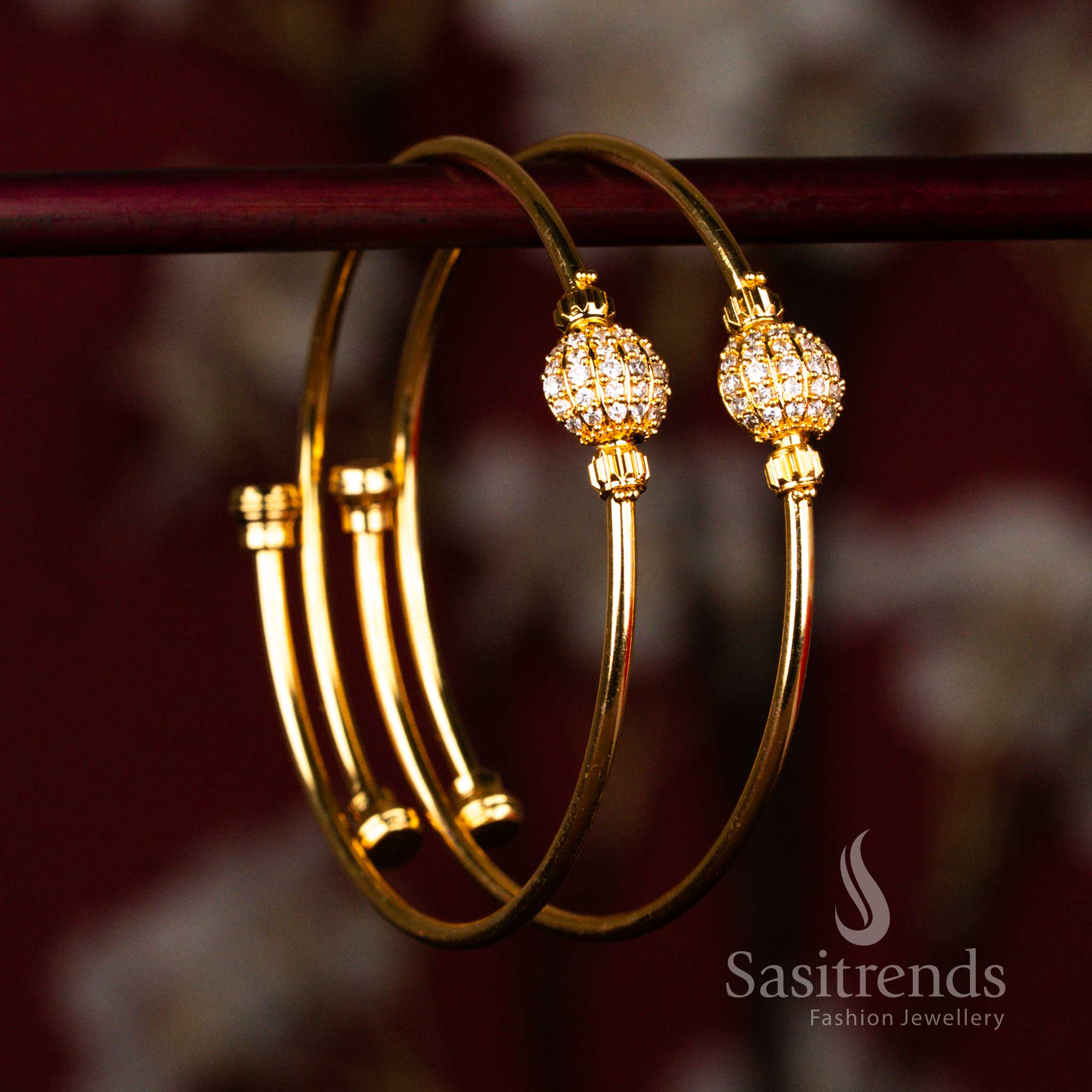 Traditional gold look bangles with polished finish and white American diamond stone ball detail for wedding styling