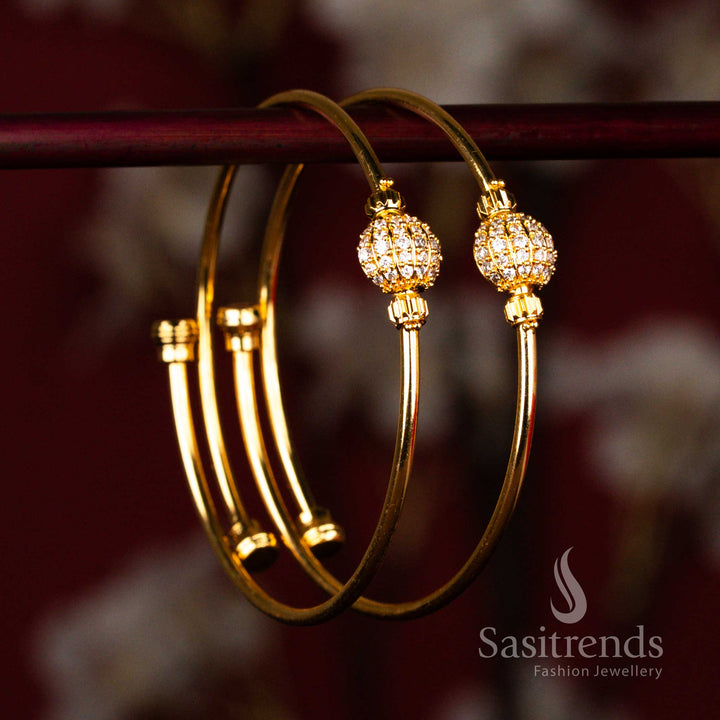 Traditional gold look bangles with polished finish and white American diamond stone ball detail for wedding styling