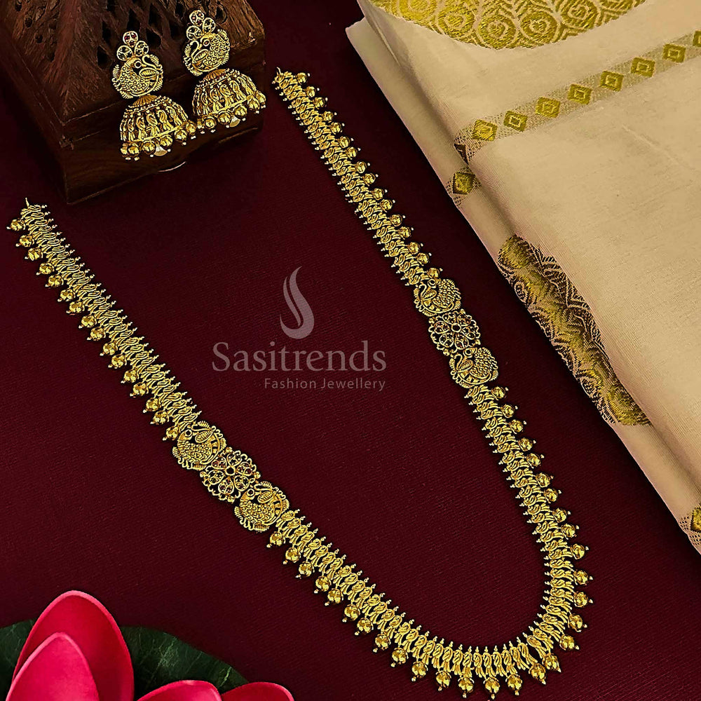 Ruby-green peacock floral bridal jewellery set with matte gold plated jhumkas, bringing together traditional glory and temple craftsmanship for wedding style by Sasitrends