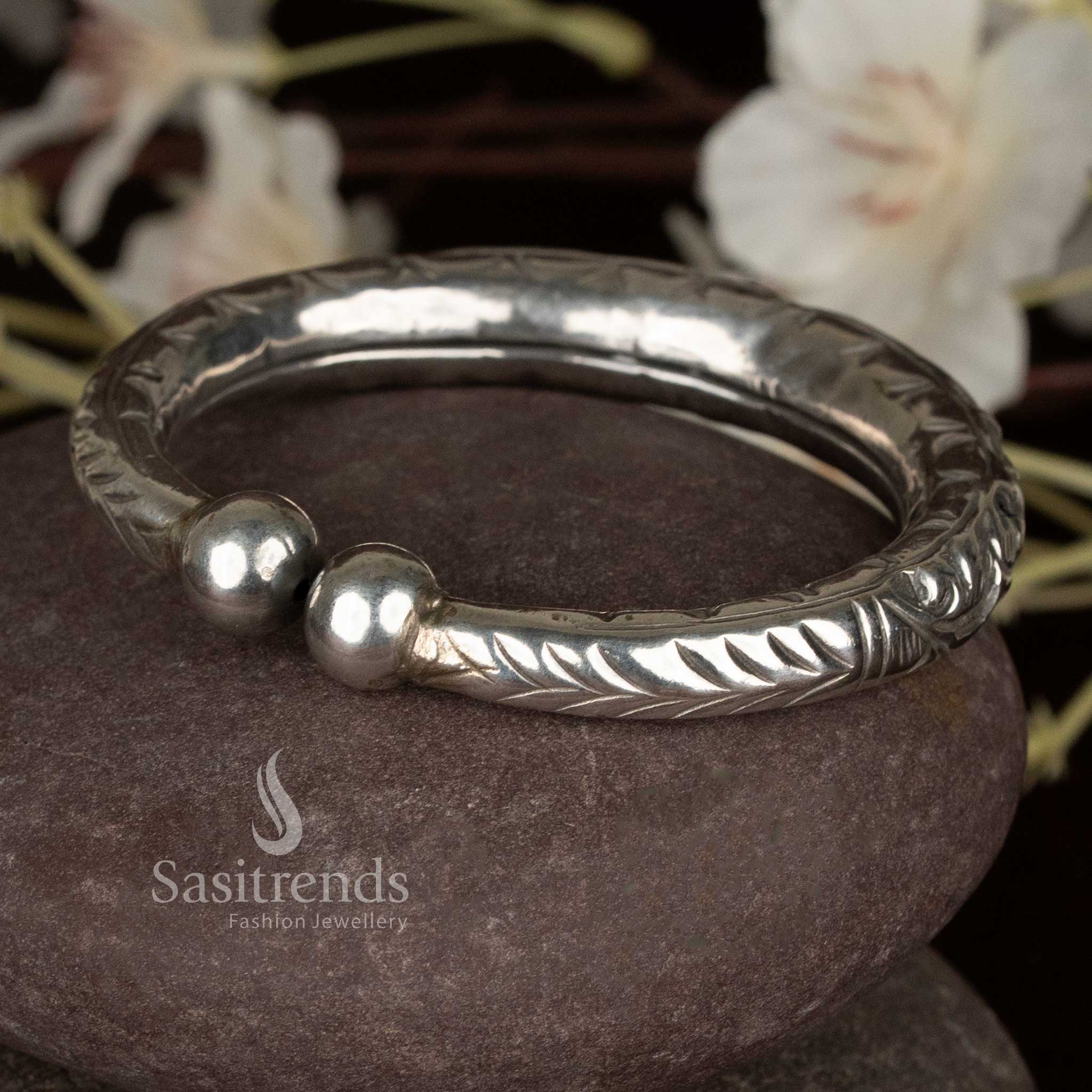 Delicate oxidised silver floral detailed kada bracelet with spherical finials, perfect for traditional styling and festive occasions – Sasitrends