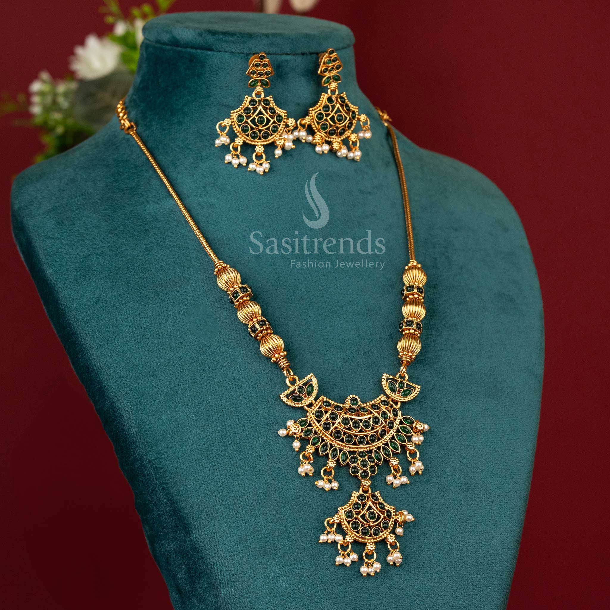 Temple-style matte gold pendant necklace with leaf green accents, sculpted deity motif and floral ethnic detailing for festive and traditional looks – Sasitrends