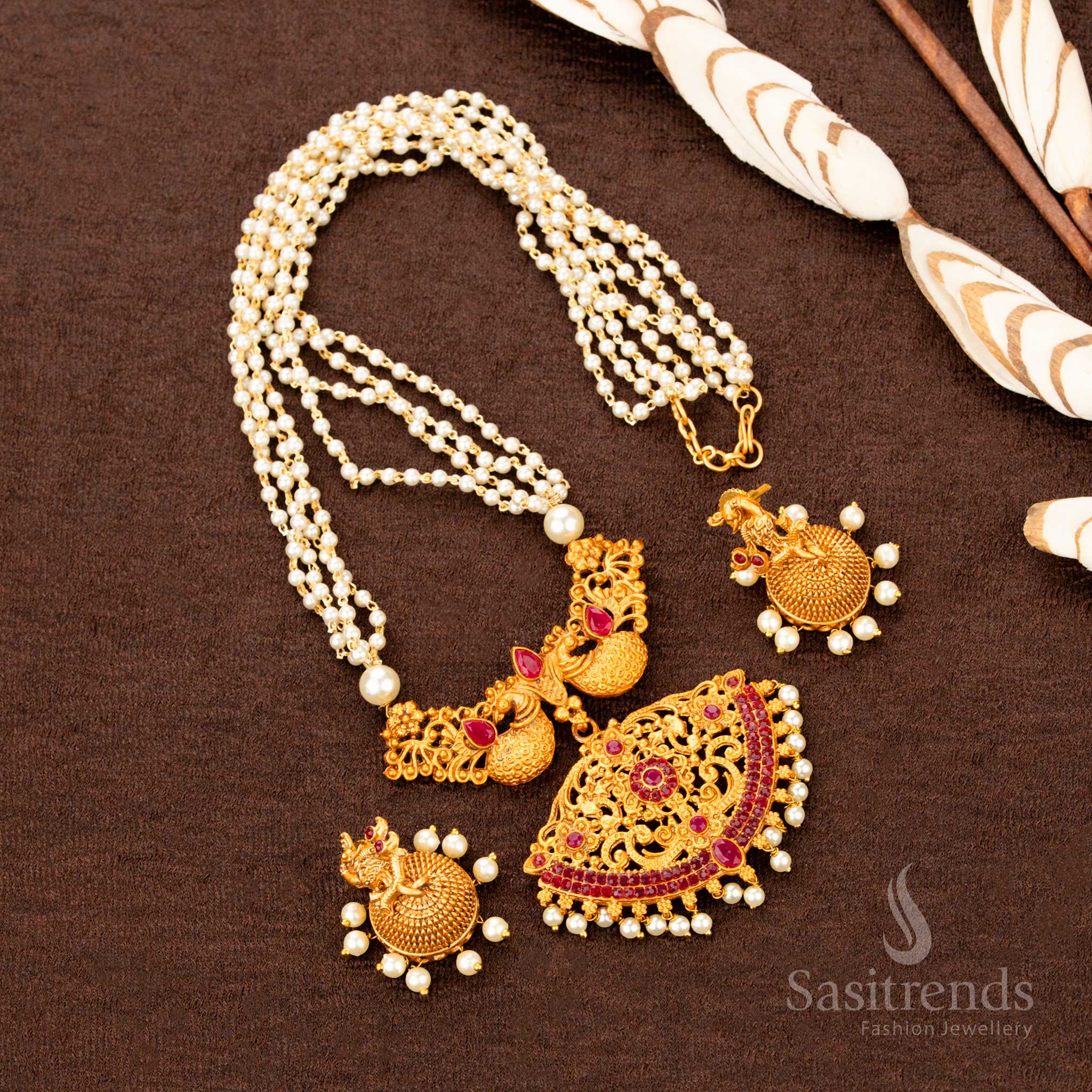 Traditional peacock temple necklace set crafted in matte gold, showcasing dual-tone ruby ZX stonework and ornate pearl jhumkas—an ethnic floral jewellery piece that radiates festive cultural bloom - Sasitrends