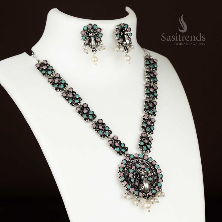 Pastel pink-mint oxidised peacock necklace crafted in German silver with pearl drops – a chic fusion jewellery set combining tradition and soft elegance from sasitrends