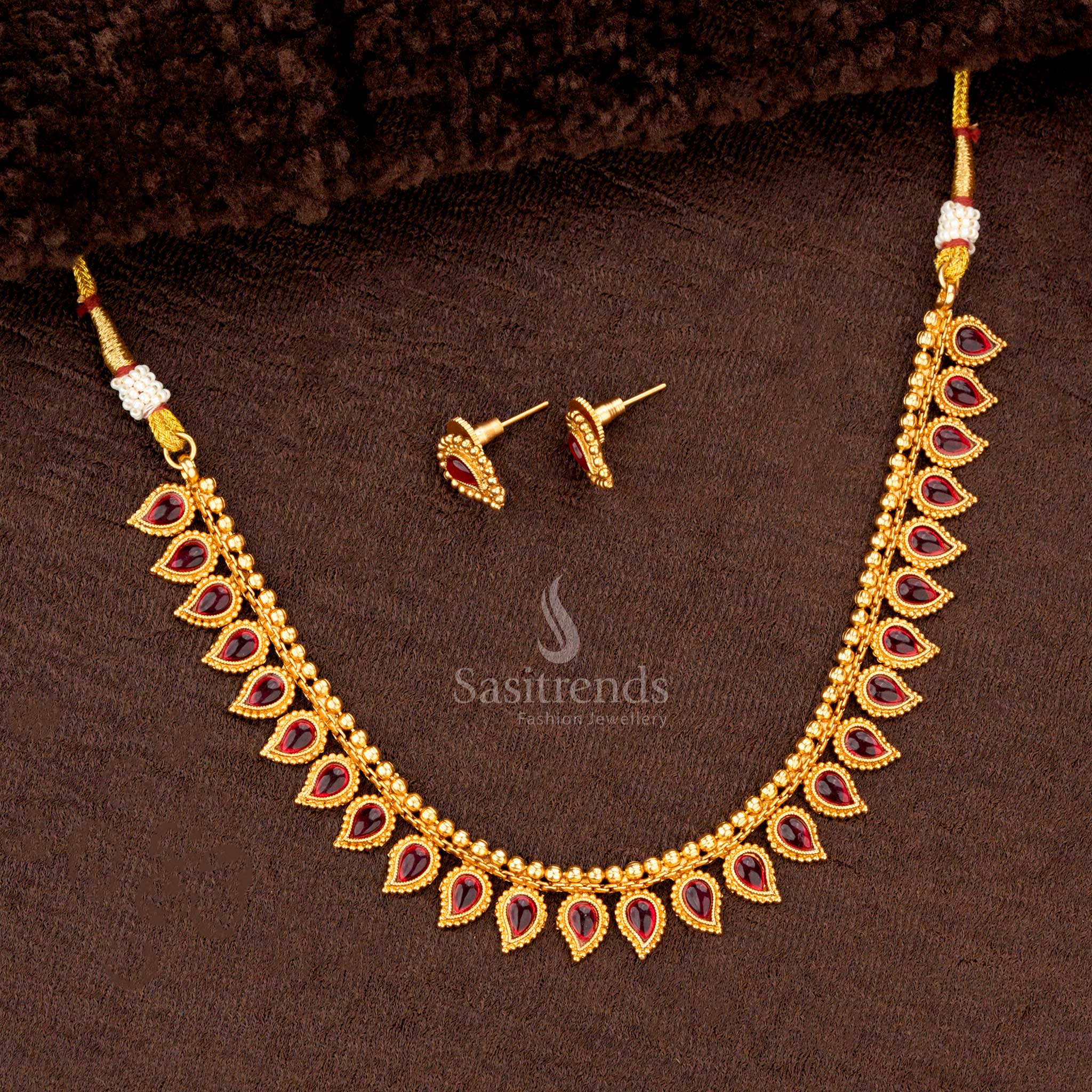Traditional necklace set with ruby teardrop motifs and matching earrings, perfect for weddings and festive occasions - Sasitrends