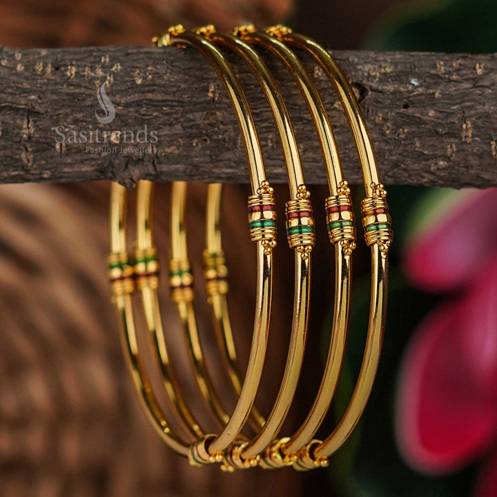Graceful trendy thin micro gold plated bangles pair with enamelled golden shine and red-green floral accented touch, featuring elegant traditional ethnic style for everyday or festive wear – sasitrends