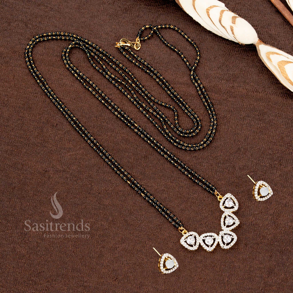Dazzling white AD pendant set with a tri-petal drop motif, paired with a micro gold plated Mangalsutra chain and matching earrings, a premium ethnic jewellery piece - Sasitrends