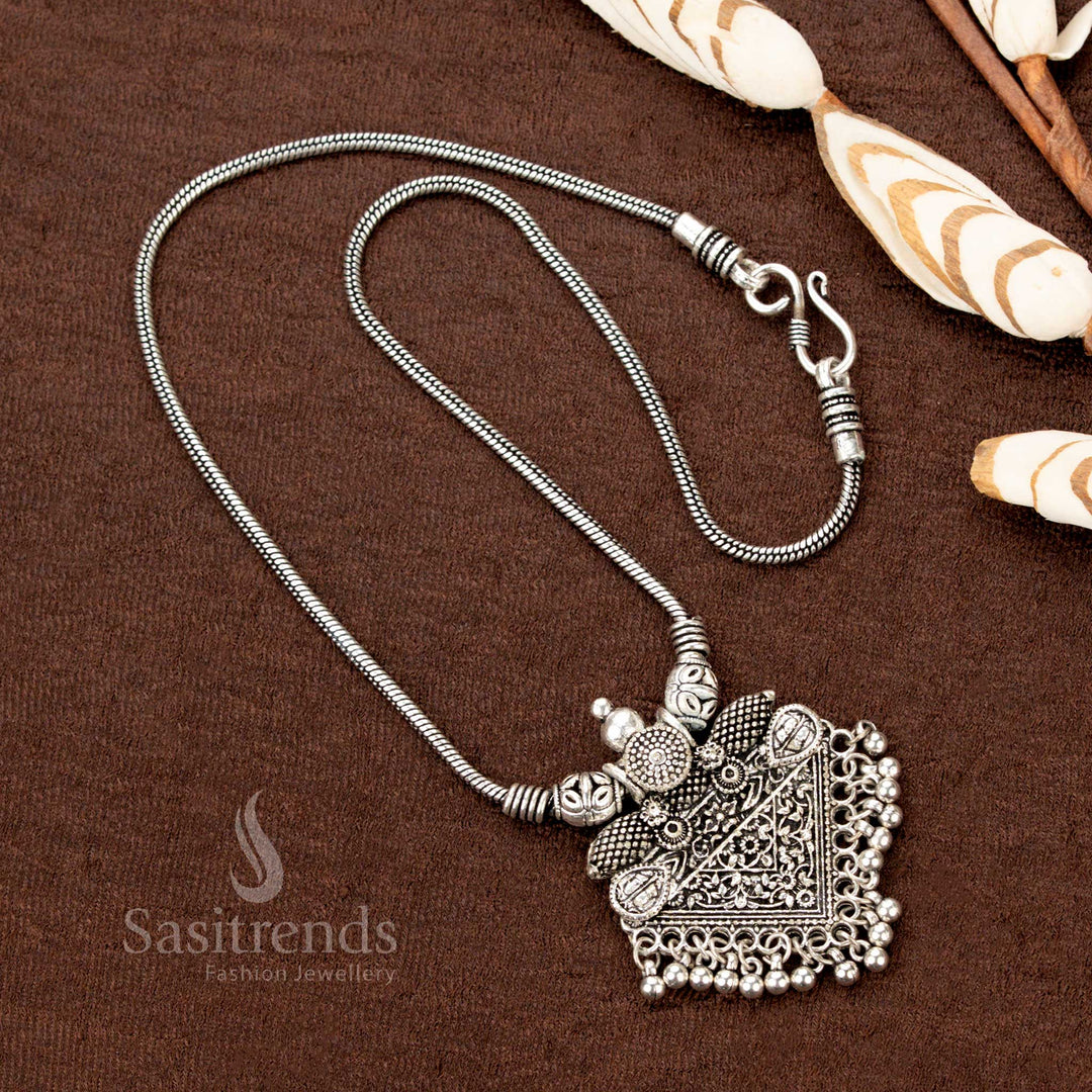 Timeless oxidised silver necklace with a beautifully crafted floral triangle pendant and classic ball drops, offering a refined touch to traditional Indian jewellery for ethnic occasions - Sasitrends