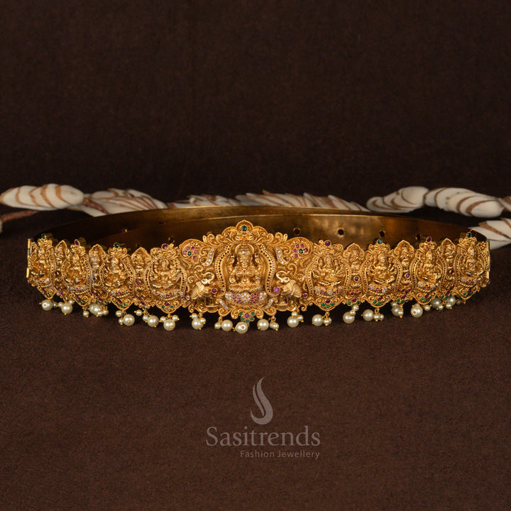 Majestic bridal hip belt in matte gold plating, featuring a divine Lakshmi centerpiece with detailed peacock and elephant motifs, adorned with radiant white pearl hangings - Sasitrends