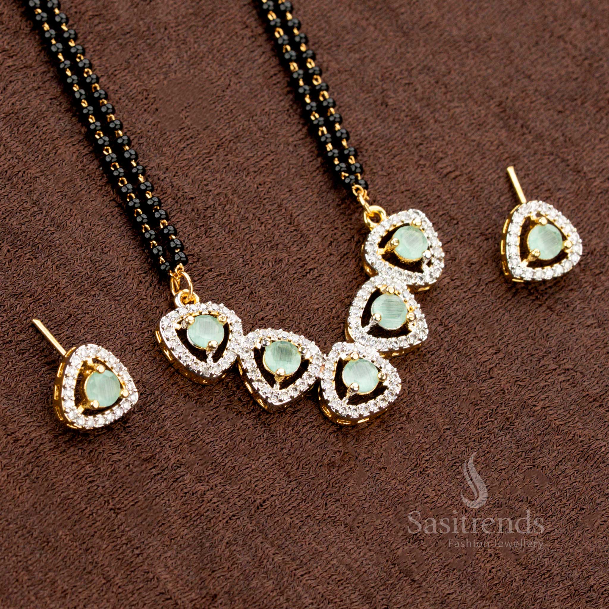 Premium mint-green American Diamond pendant set with a tri-petal drop design, paired with a micro gold plated Mangalsutra chain and matching earrings, a stunning ethnic jewellery piece - Sasitrends
