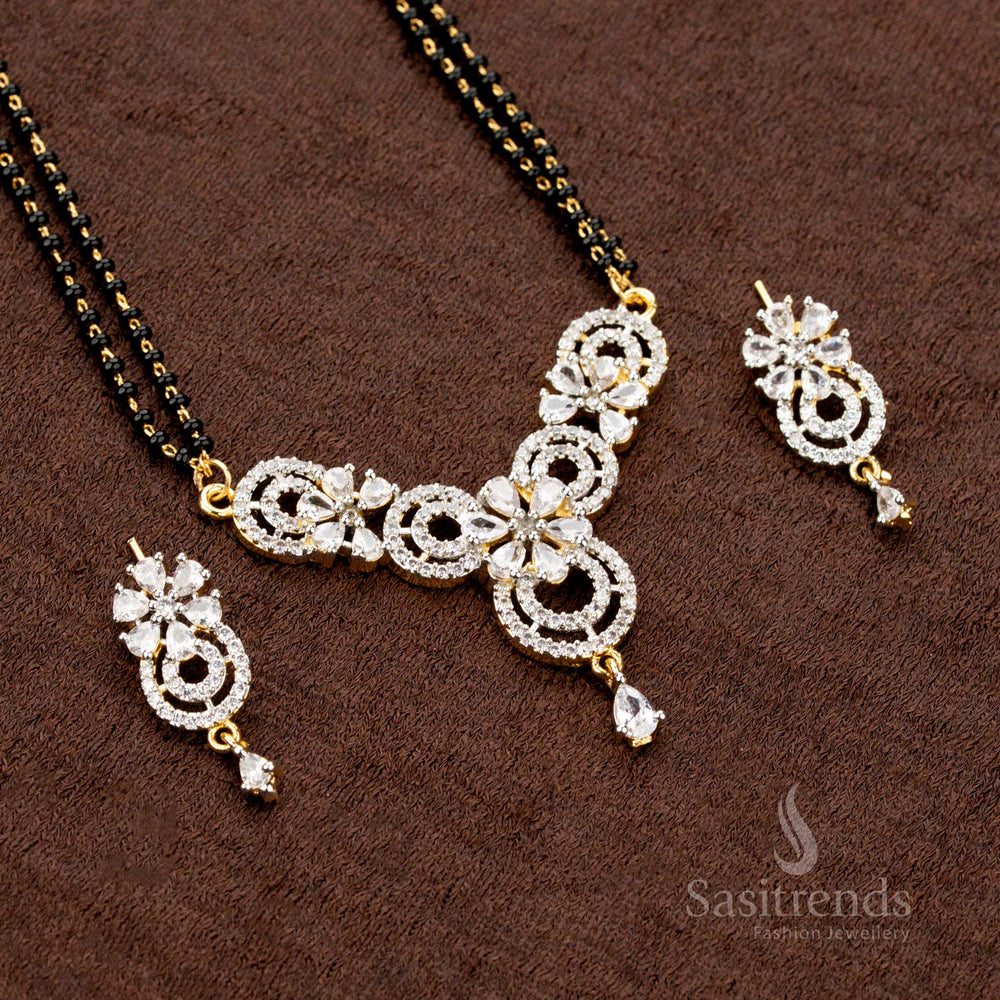 Dazzling white AD pendant set with a circular floral design, paired with a micro gold plated Mangalsutra chain and earrings, a premium jewellery piece for festive wear - Sasitrends