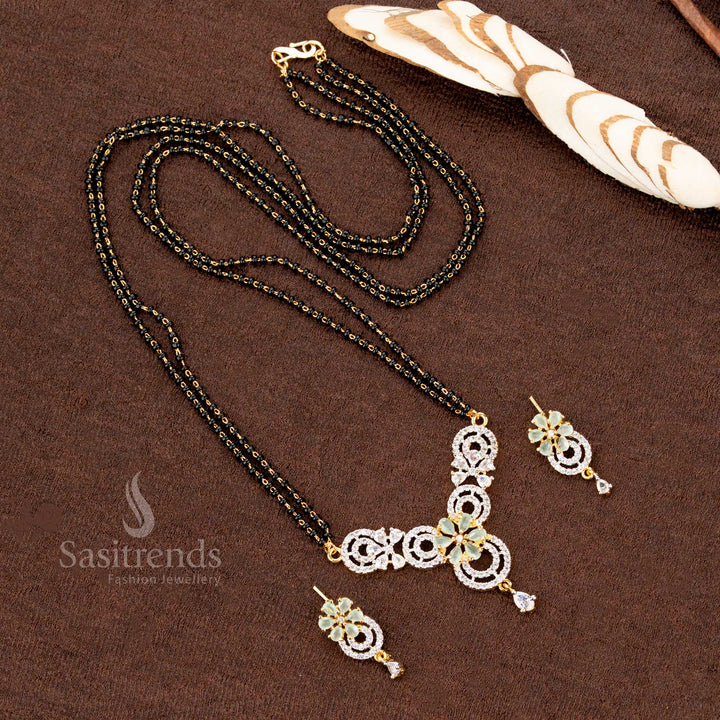 Premium mint-green American Diamond pendant set with a circular floral motif, paired with a micro gold plated Mangalsutra chain and matching earrings, a stunning ethnic jewellery choice - Sasitrends