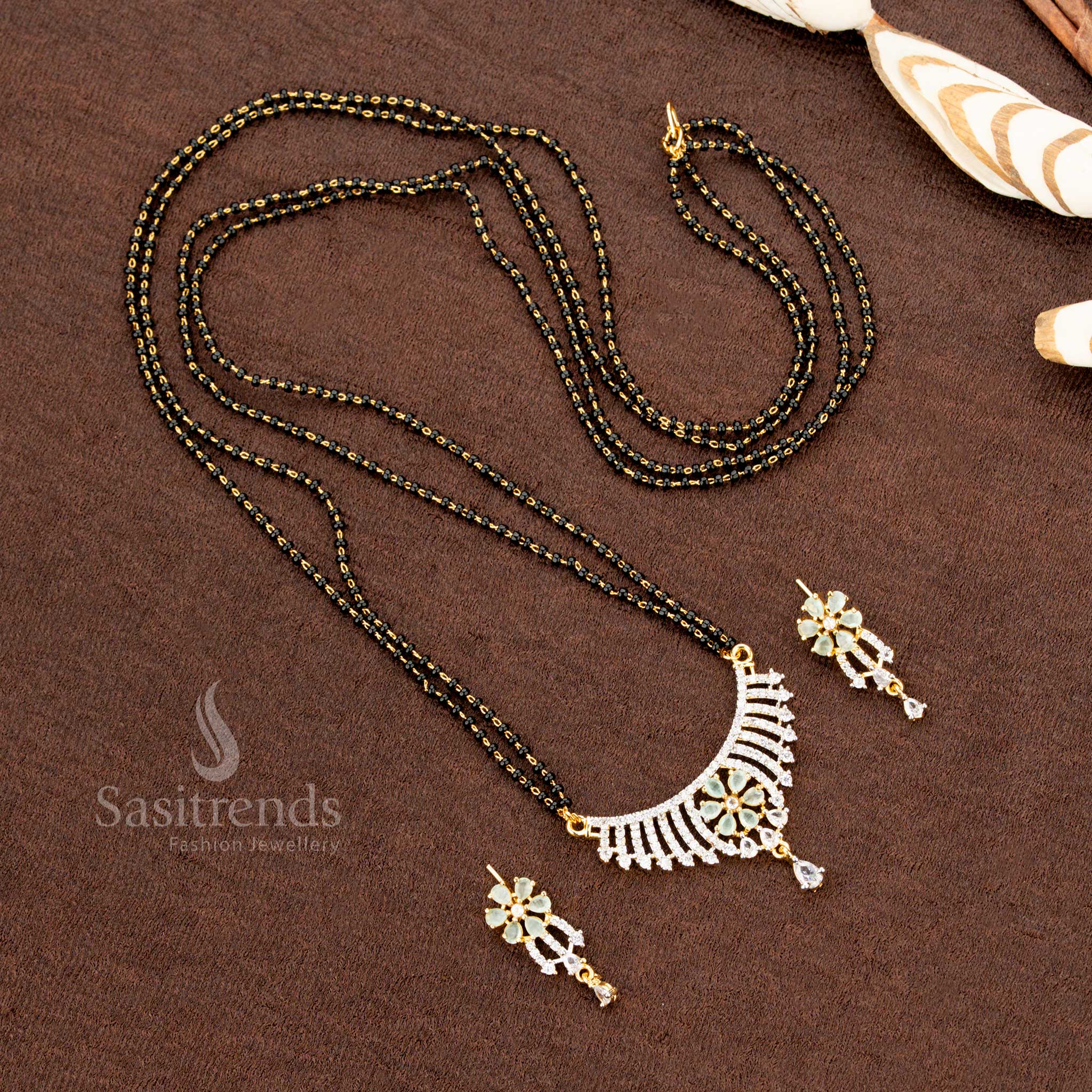 Premium mint-green American Diamond pendant set with a floral design, paired with a micro gold plated Mangalsutra chain and matching earrings, a stunning ethnic jewellery piece - Sasitrends