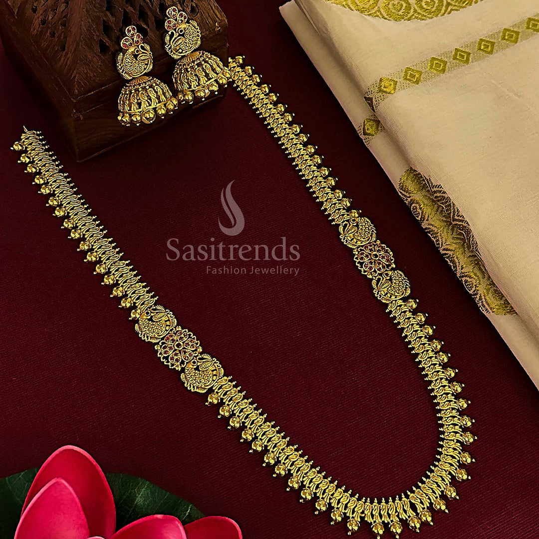 Ruby floral peacock bridal jewellery set with matte gold jhumkas, styled in luxurious temple finish, divine adornment and rich ethnic bridal appeal by Sasitrends