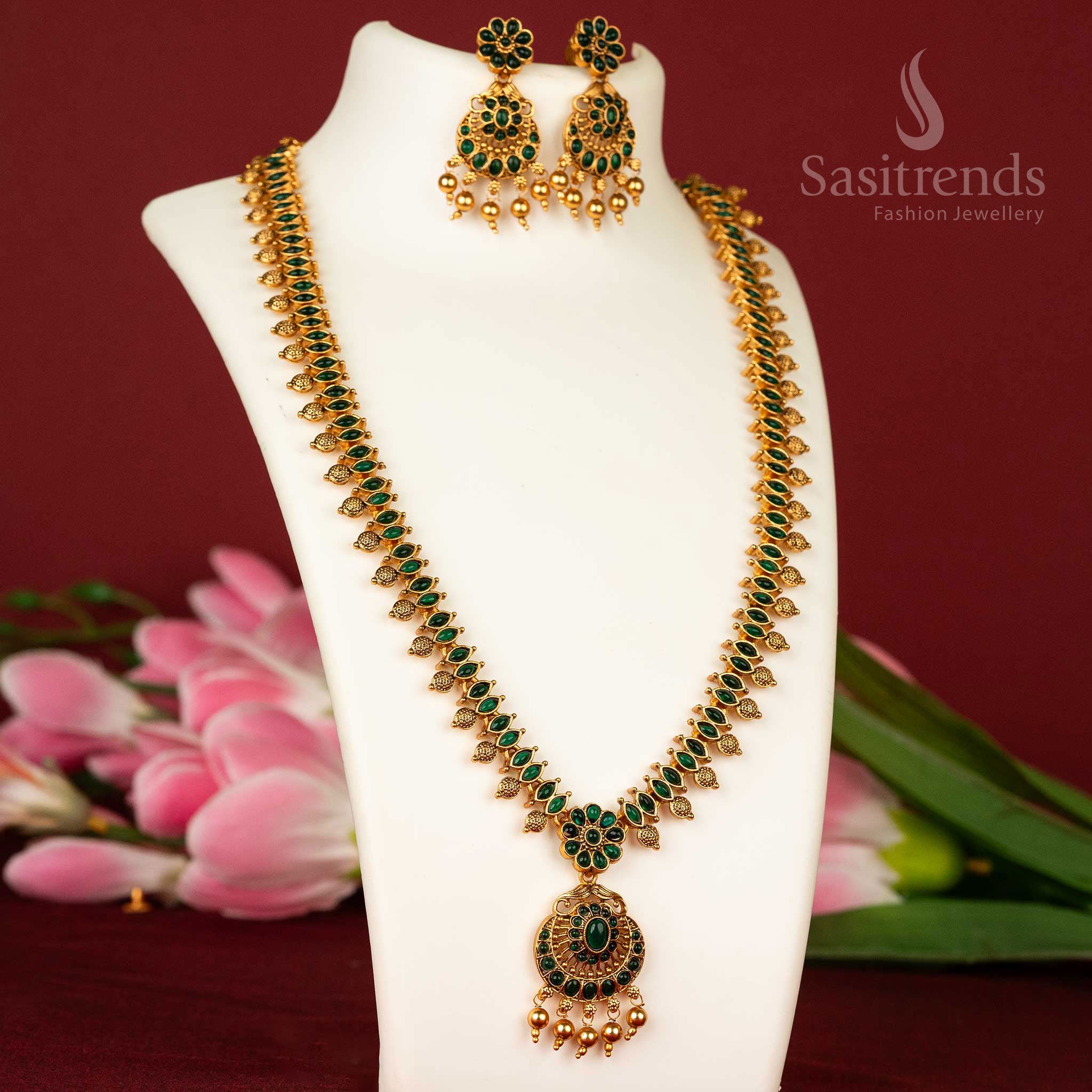 Divine temple style long haram necklace with green stones and floral matte gold detailing – a graceful jewellery piece – sasitrends